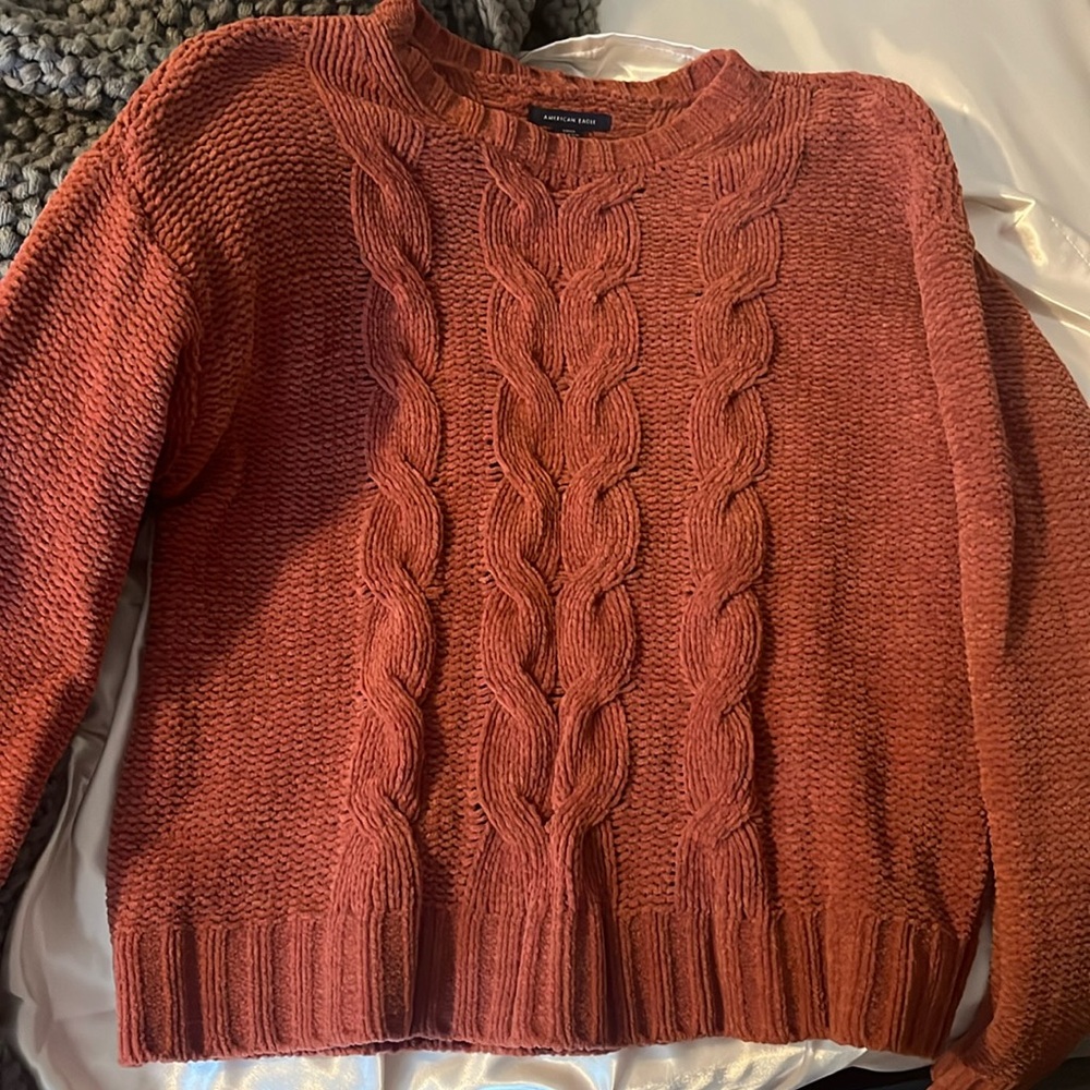 Small pink/orange sweater.
